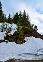 Snow in the mountains at the end of winter, snow melting in the mountains. Mountain landscape. photo