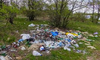 Plastic, polyethylene and glass trash in the wild, environmental pollution photo
