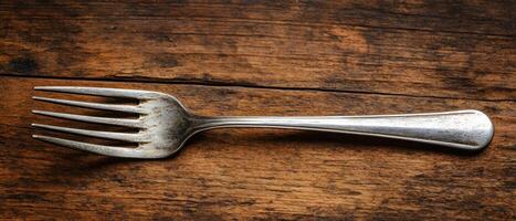 A fork on a wooden table photo
