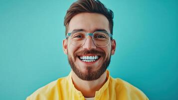 A man with glasses and a beard is smiling photo