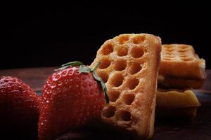 Viennese waffles in the shape of a heart lie on a clay plate. Viennese waffles with strawberries. photo
