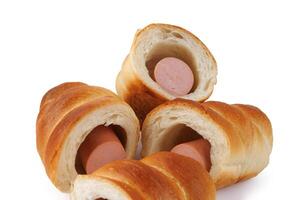 Sausages in dough cut in half isolated on a white background.Sausage in dough. photo