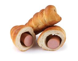 Whole and halved sausages in dough isolated on a white background. photo