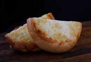 Khachapuri. Bun with cheese on a wooden background. Cheese pie. photo