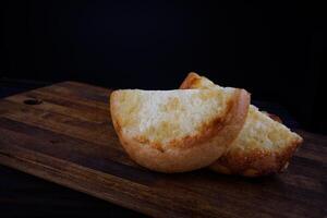 Khachapuri. Bun with cheese on a wooden background. Cheese pie. photo