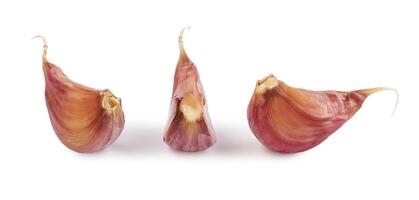 Three cloves of garlic isolated on a white background. Garlic cloves on white. photo