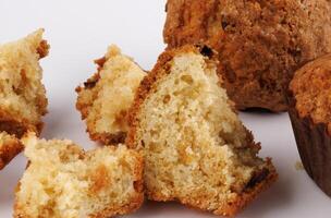 Muffin and muffin pieces on a white background. photo