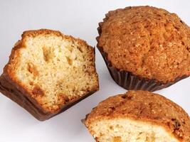 Whole and half muffin on a white background. photo