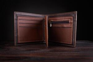 An open leather wallet on a dark background. photo