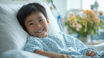 Smiling East Asian Boy in Hospital Bed with Floral Arrangement, Symbolizing Hope and Recovery photo