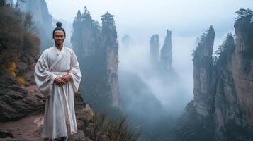 Ancient Wisdom Amidst Misty Mountains, A Daoist Monk in Traditional Robe at Majestic Mountain Range, Tranquil Nature and Serenity photo