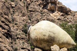 old kvevri wine vessel and cliff in background photo