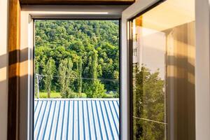 roof and forest through open window in Dilijan photo
