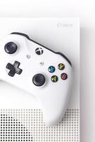 Vertical photo of Xbox One S Console and Controller on a white background close up photo