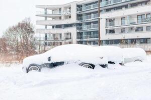 Poland, Krakow, 12.03.2023, snowfall, snowy street with cars after a blizzard photo