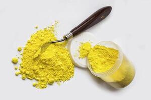 Cadmium Yellow pigment on a white background photo