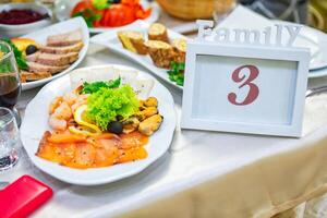Family Table Setup With Seafood Platter and Elegant Decor at a Celebration Gathering. photo