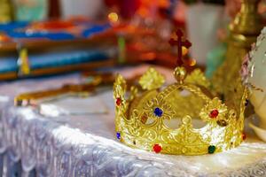 Golden Crown With Colorful Jewels Displayed on a Decorated Altar in a Serene Setting. photo