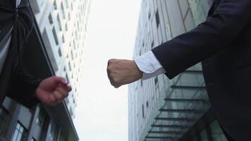 A businessman's hands are greeting in a youthful language and making a casual welcome video