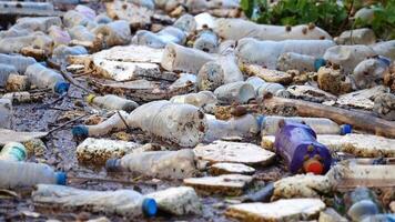 impactful image of plastic waste pollution in nature, featuring discarded bottles and debris contaminating the environment, pollution, plastic pollution and its detrimental effects on ecosystems video