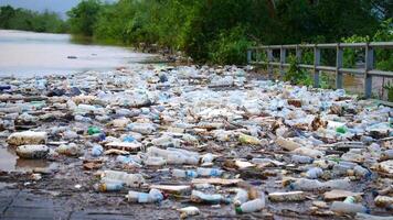 impactful image of plastic waste pollution in nature, featuring discarded bottles and debris contaminating the environment, pollution, plastic pollution and its detrimental effects on ecosystems video