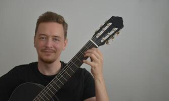 A man playing the guitar. Hands on the strings. Close-up portrait. Chord selection. Musician playing electric guitar. Banner wallpaper with copy space at the white background photo