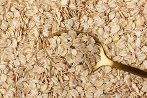 Oat flakes with golden spoon. photo