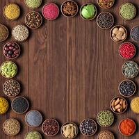 Herbs and spices over wooden table background. multicolored seasoning,top view with copy space photo