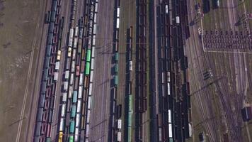 Aerial view of Railway sorting station and A lot of wagons at a railway. Drone flies over railway tracks. 4k quality video