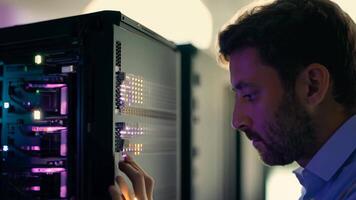 IT specialist fixing server rack glowing LED engineer system administrator backend software hardware security cloud computing AI training expert specialist technology data center network video