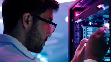 IT specialist fixing server rack glowing LED engineer system administrator backend software hardware security cloud computing AI training expert specialist technology data center network video