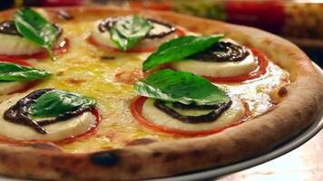 A pizza with cheese and tomatoes on top video