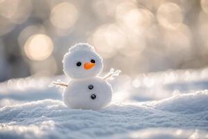 Small snowman standing on a snowy surface with bokeh background photo
