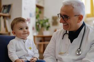 Pediatrician smiling looking at toddler boy sitting on chair photo