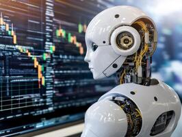 White robot analyzing declining stock market data on computer screen photo