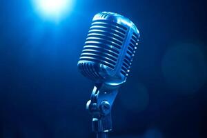 Vintage microphone standing in blue light on stage photo