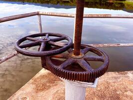 rusted industrial gears and a turning mechanism, highlighting the texture and wear of aged metal, The machinery, set against a muted background, mechanical engineering photo