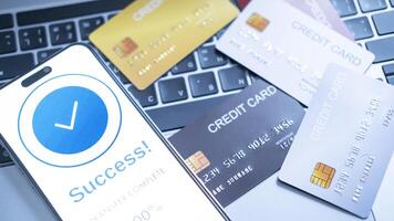 smartphone screen shows a successful payment confirmation, with a credit card. The image emphasizes digital payments, financial technology, and the convenience of secure mobile transactions. photo