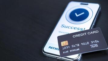 smartphone screen shows a successful payment confirmation, with a credit card. The image emphasizes digital payments, financial technology, and the convenience of secure mobile transactions. photo