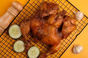 Ayam Panggang. Whole roasted chicken with soy sauce and spices. on the cooling rack. Indonesian food. photo