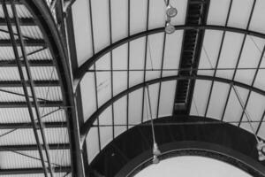 image is a black and white photo of a building with a large archway