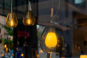window display with three light fixtures one of which is a yellow light photo