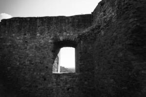 window in a stone building with a view of the sky photo