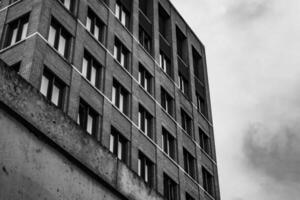 brick building with many windows and a cloudy sky in the background photo