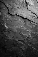 A close-up view of layered gray stone texture against a dark vertical background photo