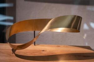 Mobius loop. Metall golden color. Mobius strip mathematical object photo