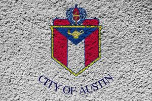 Flag of the city of Austin, Texas, USA, on a background of a plaster wall. Conceptual collage photo