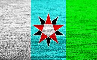 Flag of the city of Charlotte Amalie, U.S. Virgin Islands, USA, on a background of the water surface. Conceptual collage photo