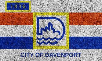 Flag of the city of Davenport, Iowa, USA, on a background of fabric texture. Conceptual collage photo