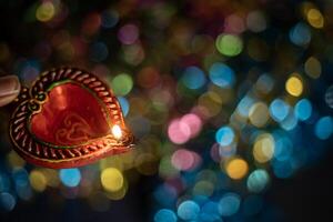 Love concept. Heart shape candle on colorful bokeh background for Valentine's day. photo